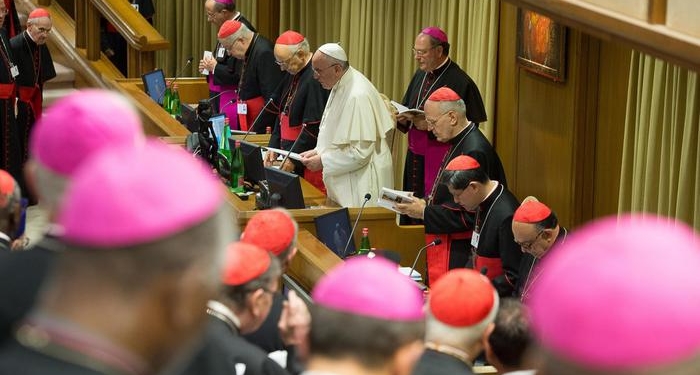 epa04435758 A handout picture provided by the Vatican newspaper L'Osservatore Romano on 07 October 2014 shows Pope Francis (C) leading the extraordinary Synod of bishops on family, at the Vatican, 06 October 2014. Catholic bishops were coming together for a two-week Synod in order to discuss church stances on family-related issues such as marriage, divorce, homosexuality, contraceptives and premarital sex.  EPA/L'OSSERVATORE ROMANO/HANDOUT  HANDOUT EDITORIAL USE ONLY/NO SALES