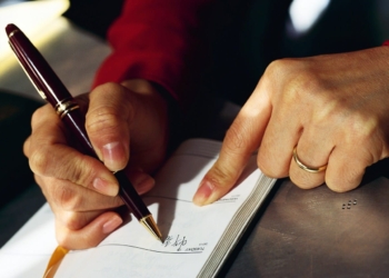 Woman Writing in Daily Planner