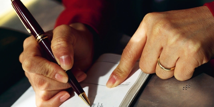 Woman Writing in Daily Planner