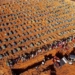 Aerial view of cemetery workers unloading a coffin from a truck at an area where new graves have been dug at the Parque Taruma cemetery, during the COVID-19 coronavirus pandemic in Manaus, Amazonas state, Brazil, on April 21, 2020. - The new area of the cemetery houses graves for suspected and confirmed victims of the COVID-19 coronavirus pandemic. (Photo by MICHAEL DANTAS / AFP)