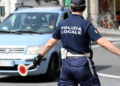 San Remo, Italy - June 10, 2018: Italian Policeman (Polizia Locale) in Uniform Controlling Road Traffic in The City Center of San Remo, Liguria, Italy