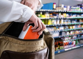 Retail Shoplifting. Woman Stealing In Supermarket. Theft At Shop